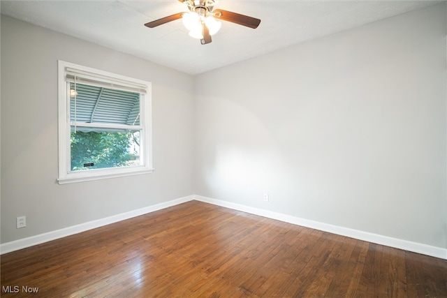 spare room with hardwood / wood-style floors and ceiling fan