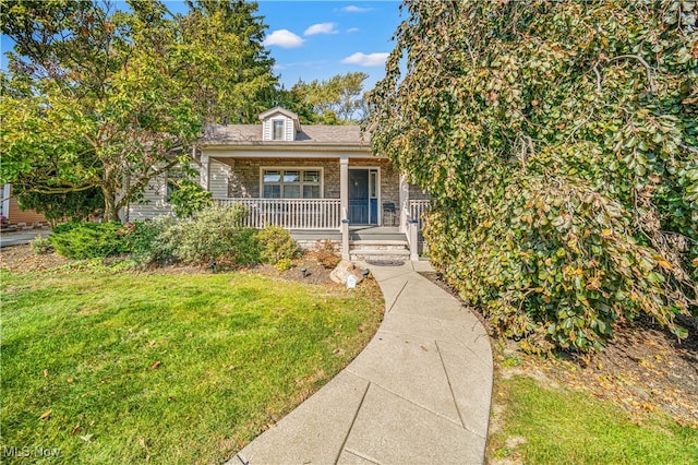 view of front of house with covered porch and a front yard