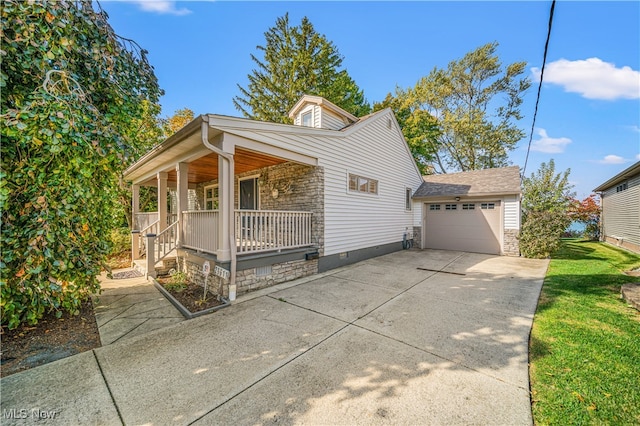 view of front of house with a garage, a front lawn, and a porch