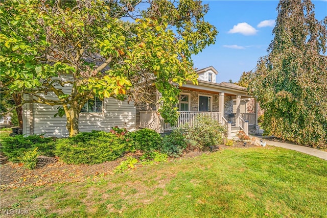 view of front of home featuring covered porch and a front yard