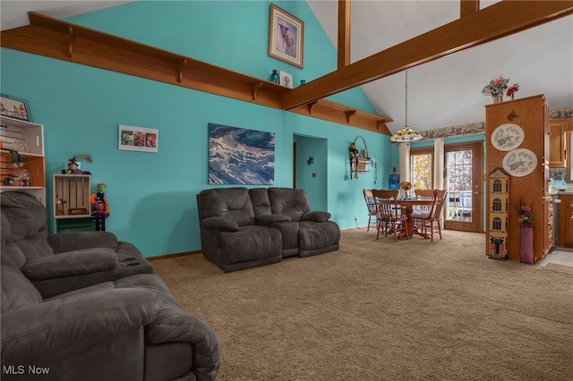 living room with beam ceiling, carpet floors, and high vaulted ceiling