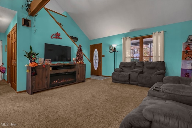 carpeted living room with high vaulted ceiling