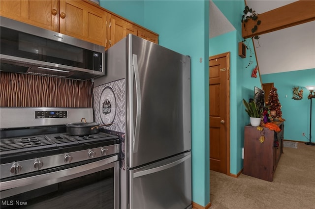 kitchen featuring stainless steel appliances and light colored carpet