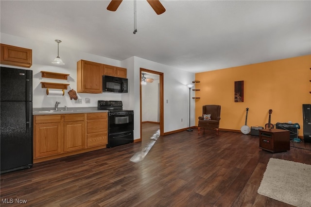 kitchen featuring hanging light fixtures, sink, black appliances, dark hardwood / wood-style flooring, and ceiling fan