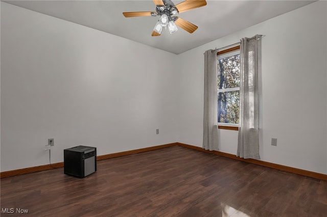 empty room featuring ceiling fan and dark hardwood / wood-style flooring