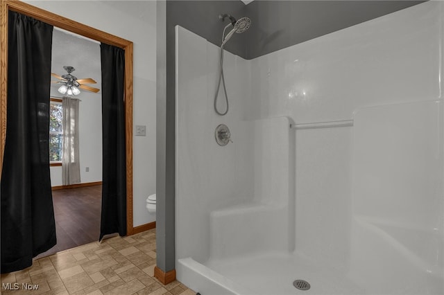 bathroom featuring ceiling fan, wood-type flooring, toilet, and walk in shower