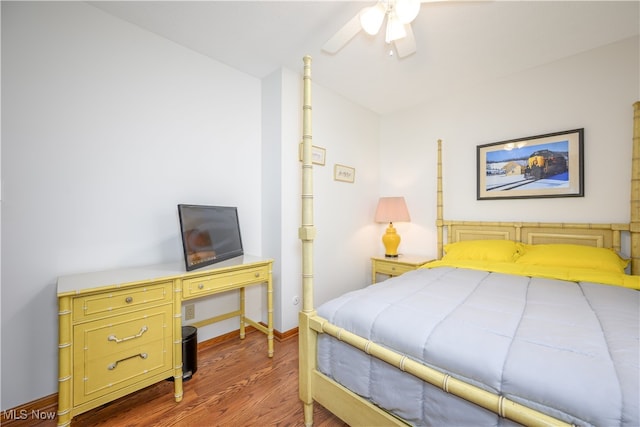 bedroom with dark hardwood / wood-style floors and ceiling fan