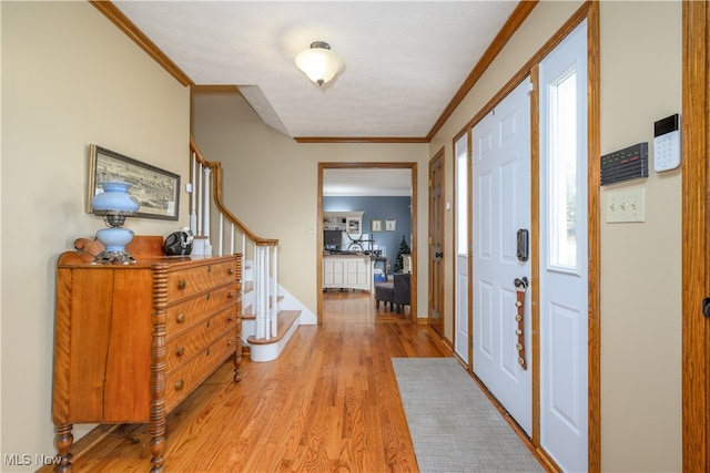 entrance foyer featuring light hardwood / wood-style floors and ornamental molding