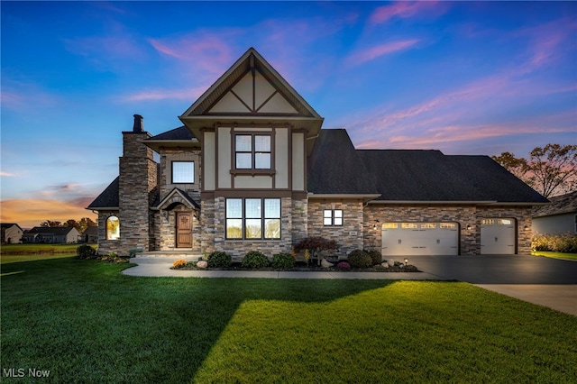 view of front of home featuring a garage and a yard