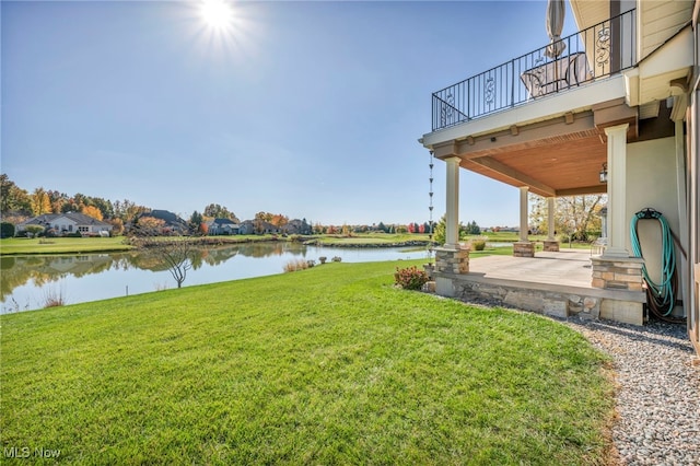 view of yard with a patio area and a water view