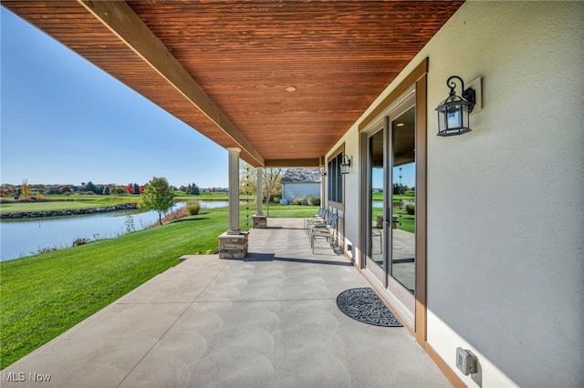 view of patio with a water view