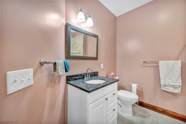 bathroom featuring tile patterned floors, vanity, and toilet