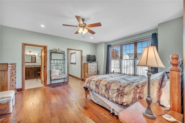 bedroom with connected bathroom, light wood-type flooring, and ceiling fan