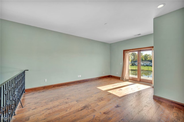 unfurnished room featuring hardwood / wood-style floors