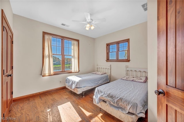 bedroom with light wood-type flooring and ceiling fan