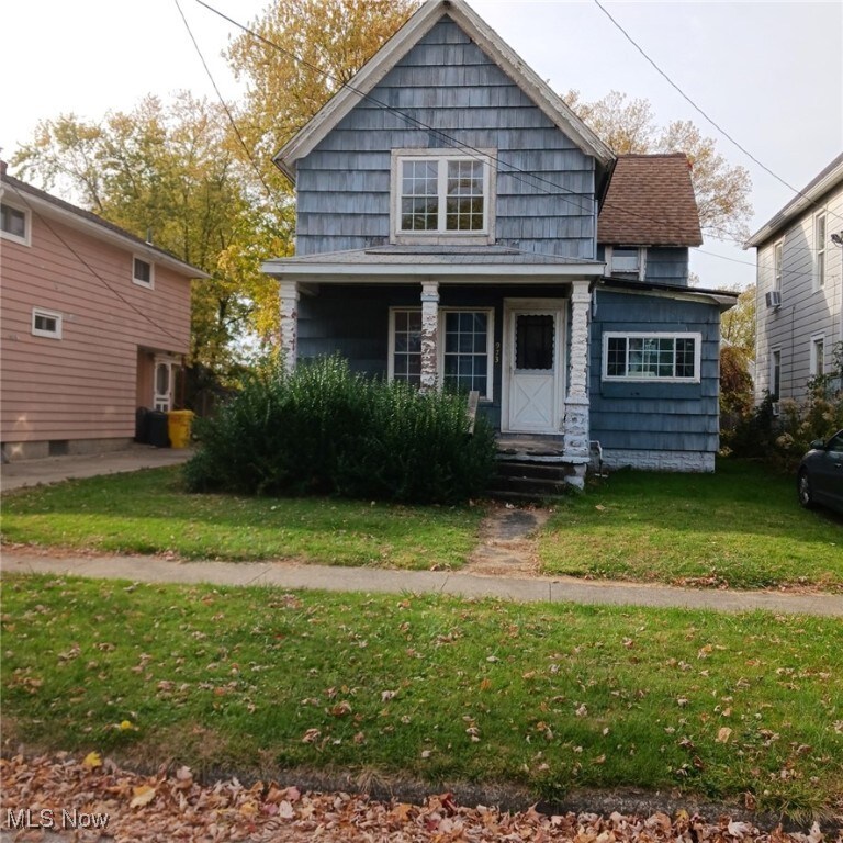 bungalow-style house featuring a front yard