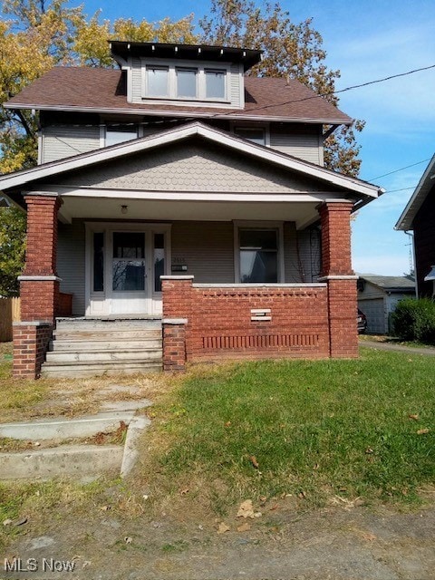 view of front facade with a front lawn and covered porch