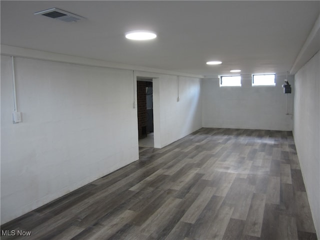 basement featuring dark hardwood / wood-style flooring