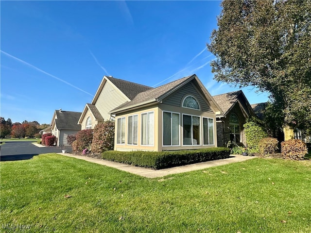 view of property exterior with a lawn