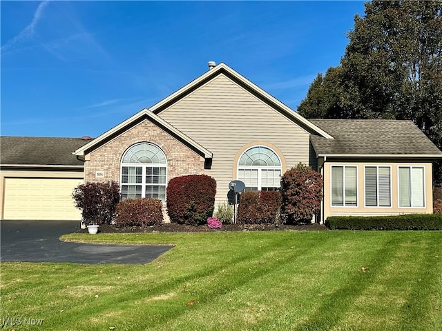 view of front of home featuring a front lawn and a garage