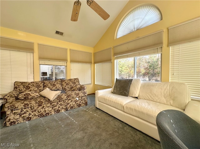 carpeted living room featuring high vaulted ceiling, a healthy amount of sunlight, and ceiling fan