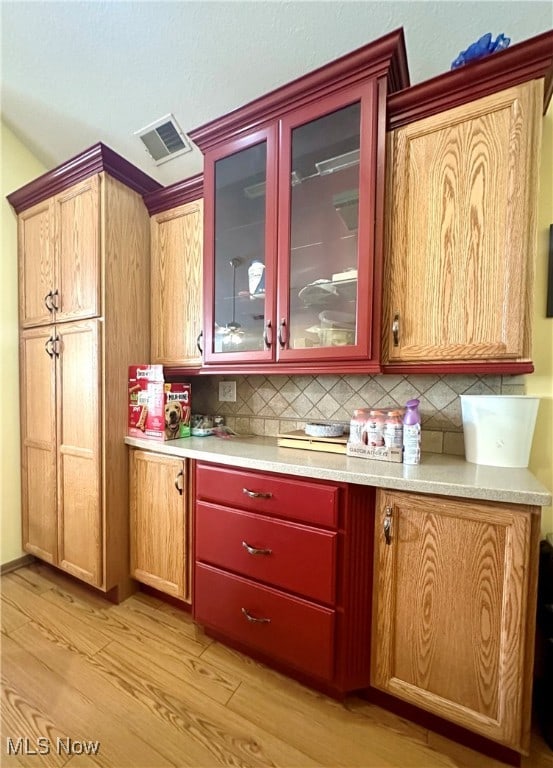 kitchen featuring tasteful backsplash and light wood-type flooring