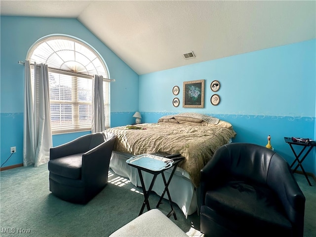 carpeted bedroom featuring a textured ceiling, vaulted ceiling, and multiple windows