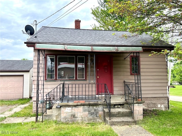 bungalow featuring a porch and a garage