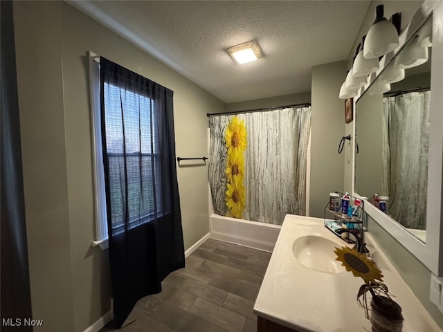 bathroom with vanity, hardwood / wood-style floors, a textured ceiling, and shower / tub combo