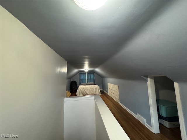 bedroom featuring dark hardwood / wood-style flooring and vaulted ceiling