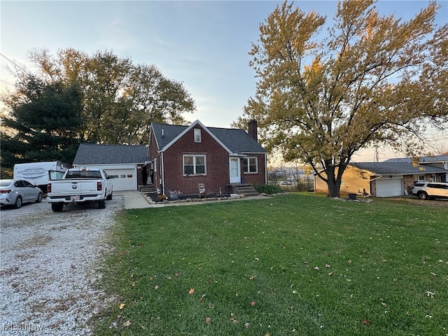 view of front of property featuring a yard and a garage