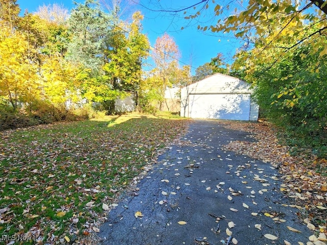 exterior space featuring a garage and an outbuilding