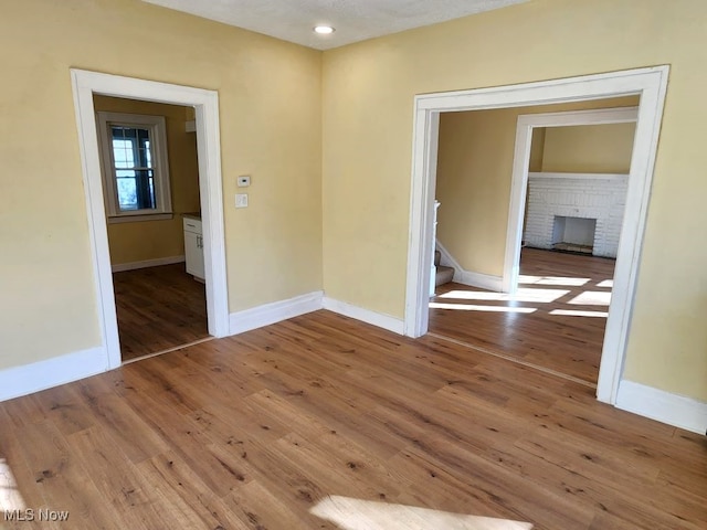 empty room with hardwood / wood-style floors and a textured ceiling