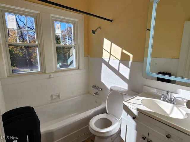 full bathroom featuring toilet, tasteful backsplash, vanity, and shower / washtub combination