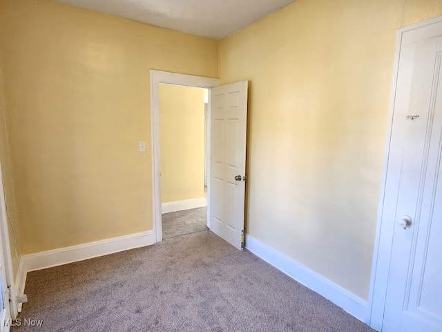 unfurnished bedroom with light colored carpet