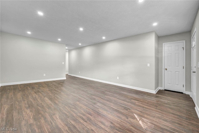 spare room with dark hardwood / wood-style floors