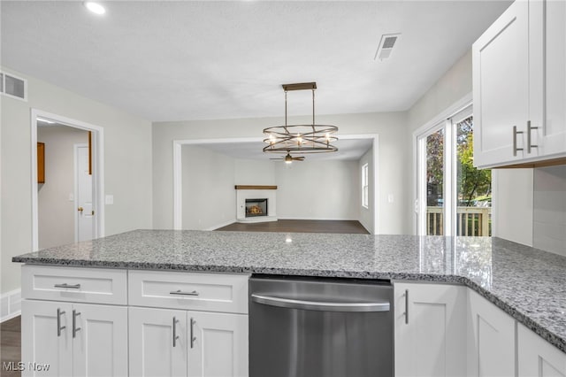 kitchen with decorative light fixtures, dishwasher, light stone countertops, and white cabinets