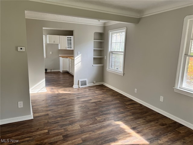 interior space featuring ornamental molding and dark hardwood / wood-style floors