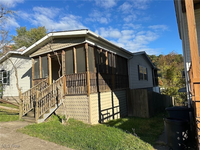 view of front of home with a sunroom