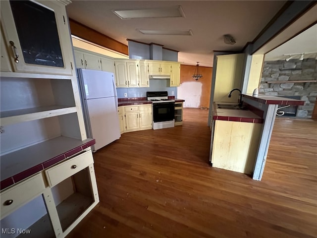 kitchen with white appliances, sink, decorative light fixtures, tile counters, and dark wood-type flooring