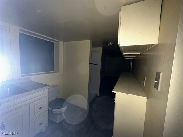 kitchen featuring white cabinetry and sink