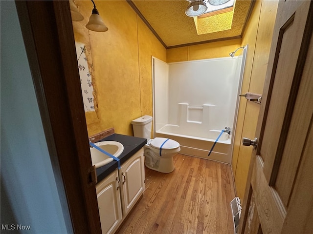 full bathroom featuring shower / bathing tub combination, a textured ceiling, toilet, vanity, and hardwood / wood-style flooring