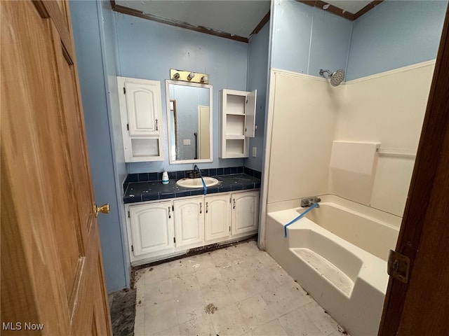 bathroom featuring  shower combination, vanity, and crown molding