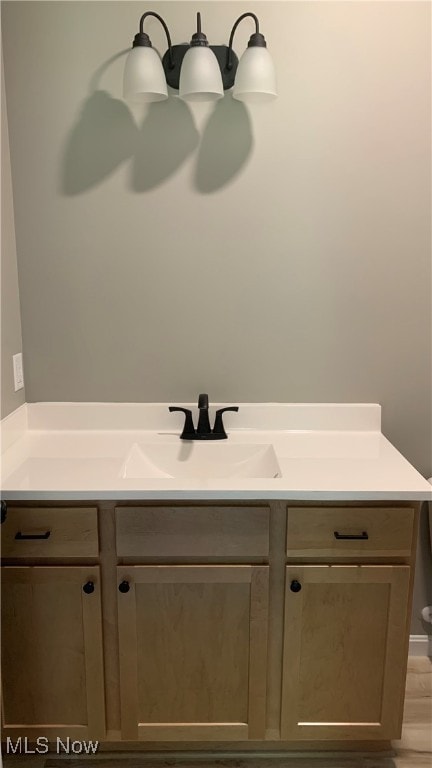 bathroom featuring vanity and hardwood / wood-style flooring