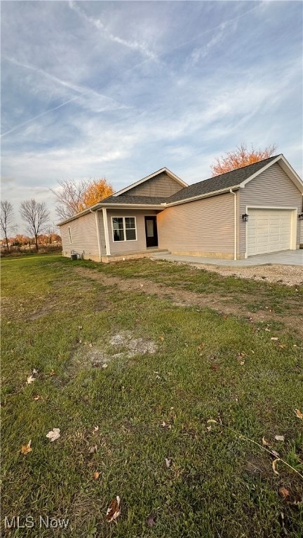 single story home with a front yard and a garage