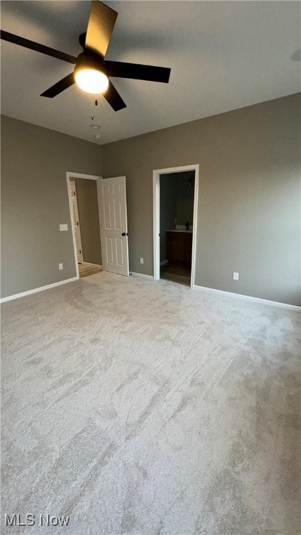 unfurnished bedroom with light colored carpet and ceiling fan