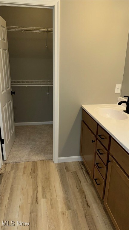 bathroom with vanity and hardwood / wood-style flooring