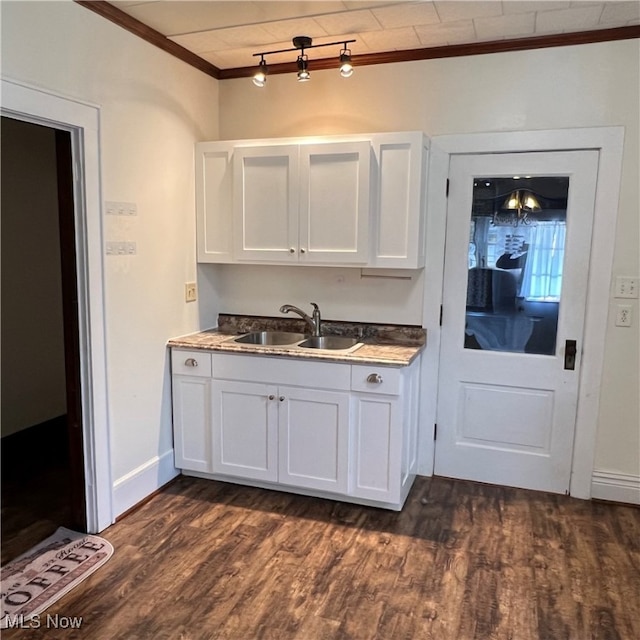 kitchen with white cabinetry, crown molding, sink, and dark hardwood / wood-style flooring