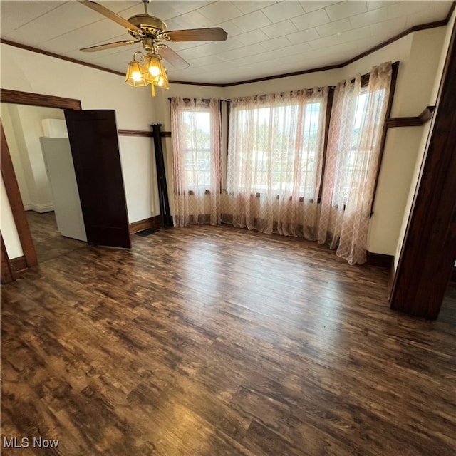 empty room featuring ornamental molding, ceiling fan, and dark hardwood / wood-style flooring