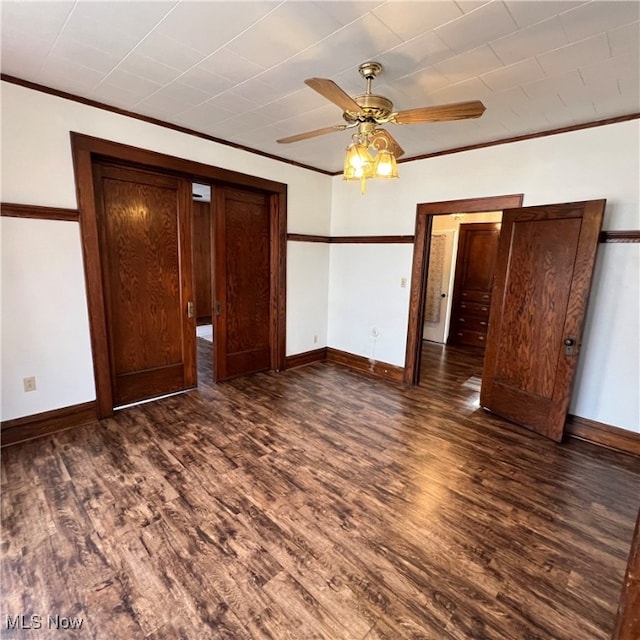 unfurnished bedroom with ornamental molding, dark hardwood / wood-style floors, and ceiling fan